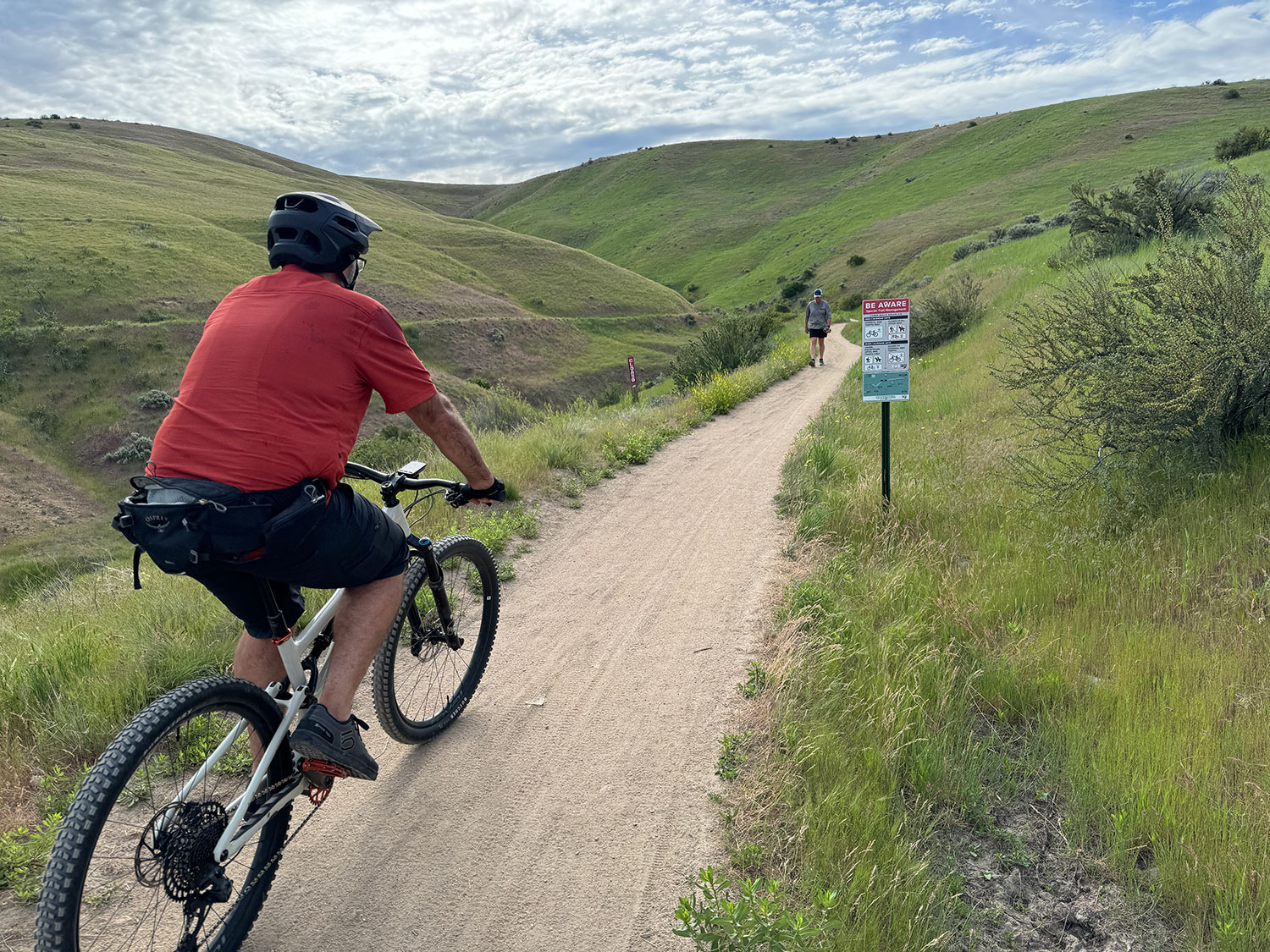 If you’re a cyclist traveling around 10 mph, would you be able to see what this sign says? Considering the beautiful scenery in your immediate vision - it would be easy to miss.